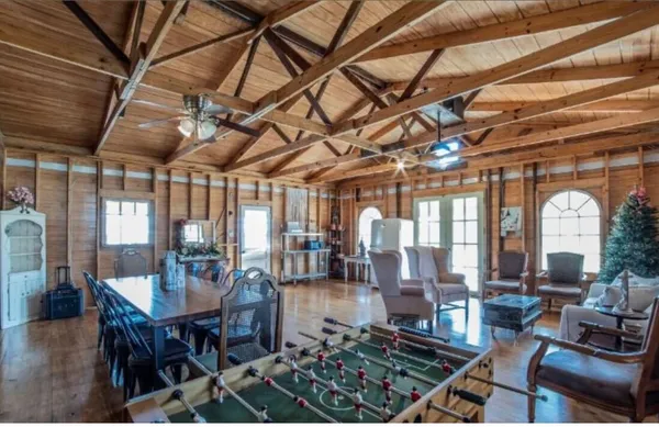 a living room with lots of furniture and a chandelier