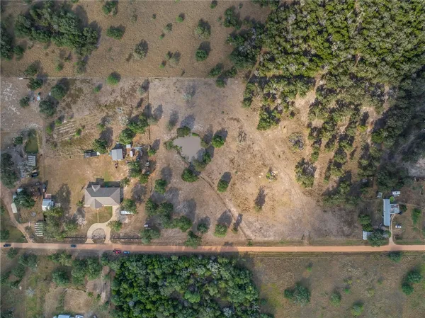 a view of a bunch of trees in front of house
