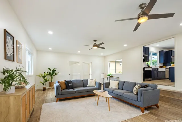 a living room with furniture potted plant and a window