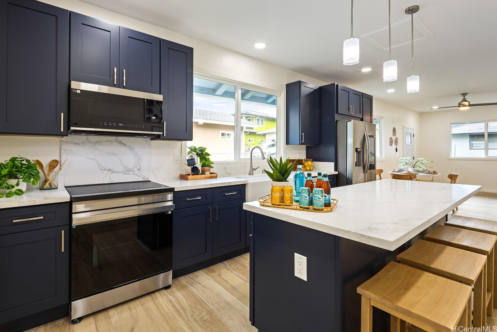 45-510 Mahinui Road, Unit B Kaneohe, HI 96744 - Photo 12 of 19 a kitchen with stainless steel appliances a stove refrigerator sink and microwave