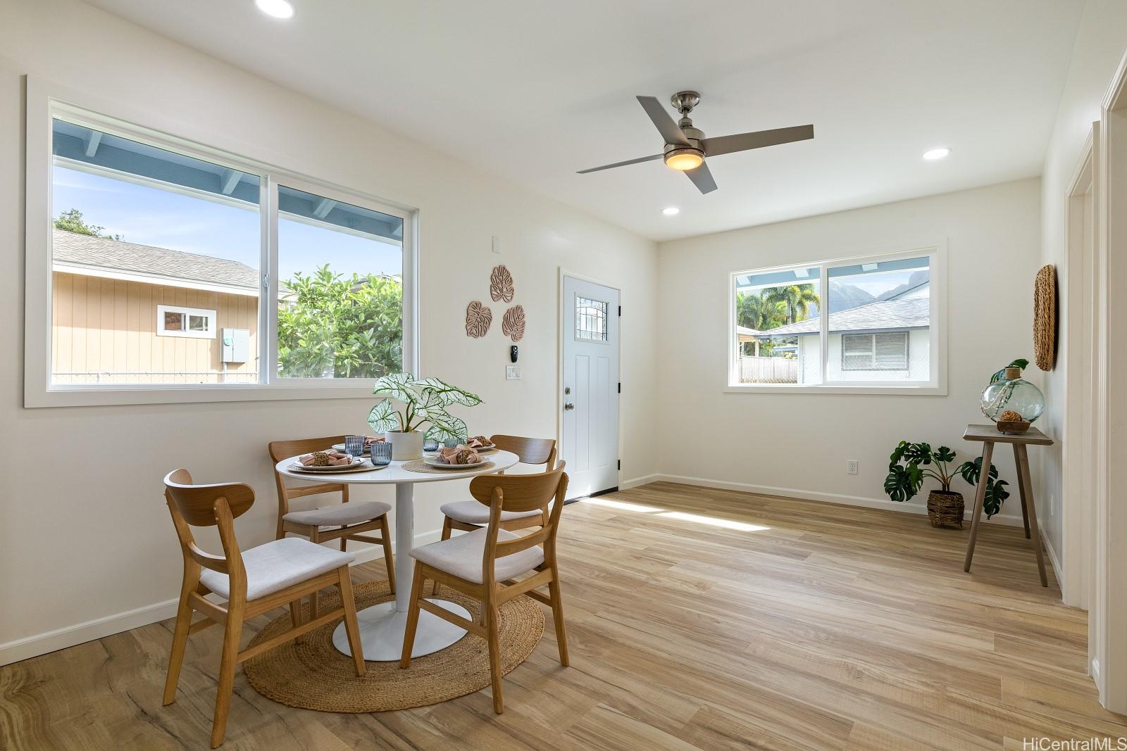 45-510 Mahinui Road, Unit B Kaneohe, HI 96744 - Photo 13 of 19 a dining room with wooden floor and a window