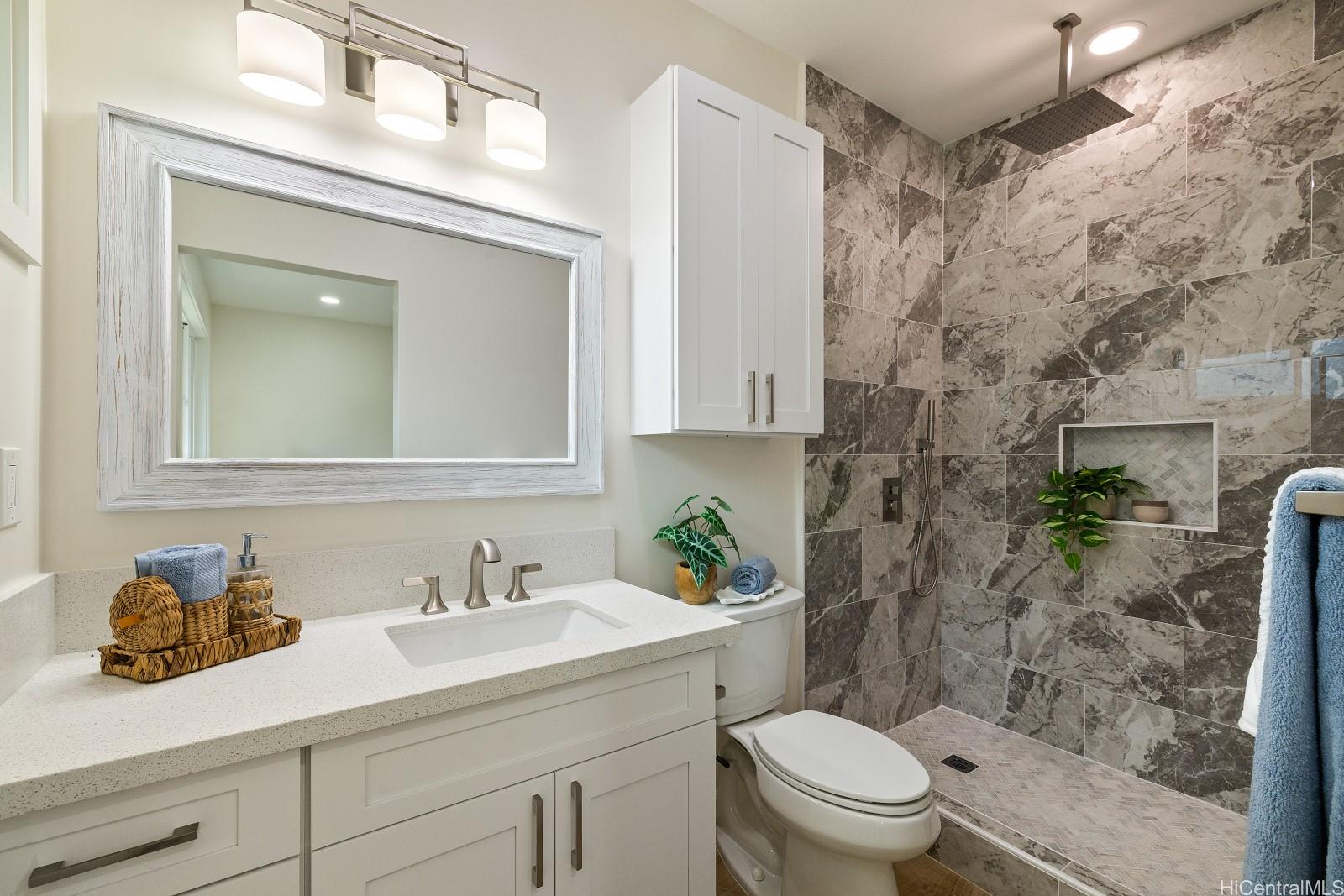 45-510 Mahinui Road, Unit B Kaneohe, HI 96744 - Photo 8 of 19 a bathroom with a sink vanity mirror and toilet