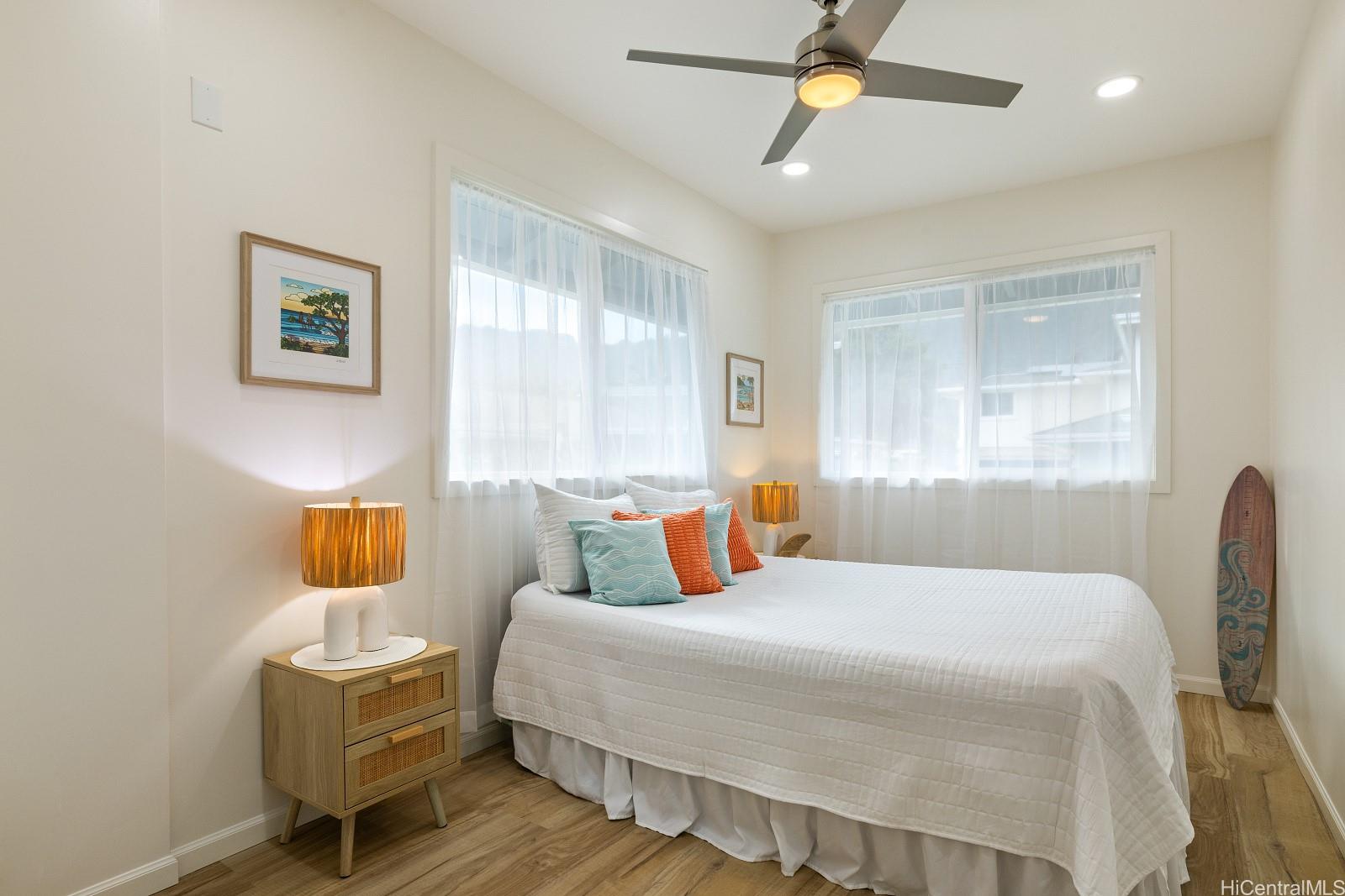 45-510 Mahinui Road, Unit B Kaneohe, HI 96744 - Photo 9 of 19 a bedroom with a bed a window and couch