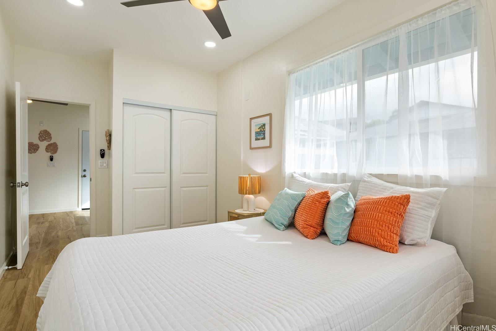 45-510 Mahinui Road, Unit B Kaneohe, HI 96744 - Photo 10 of 19 a bedroom with a large bed and a chandelier