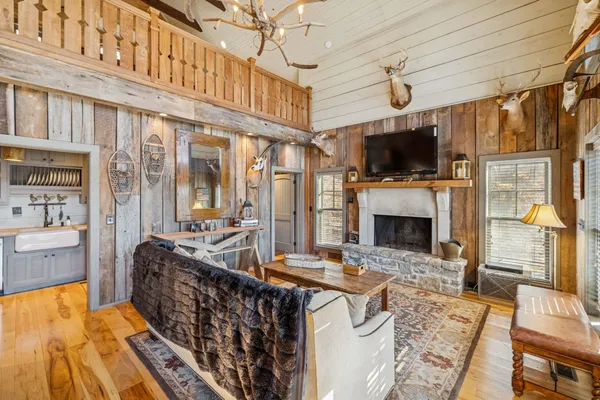 a living room with furniture a flat screen tv and a fireplace