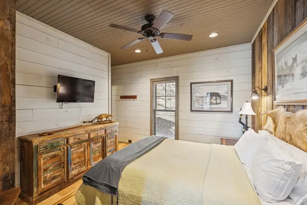 a bedroom with a bed and a chandelier