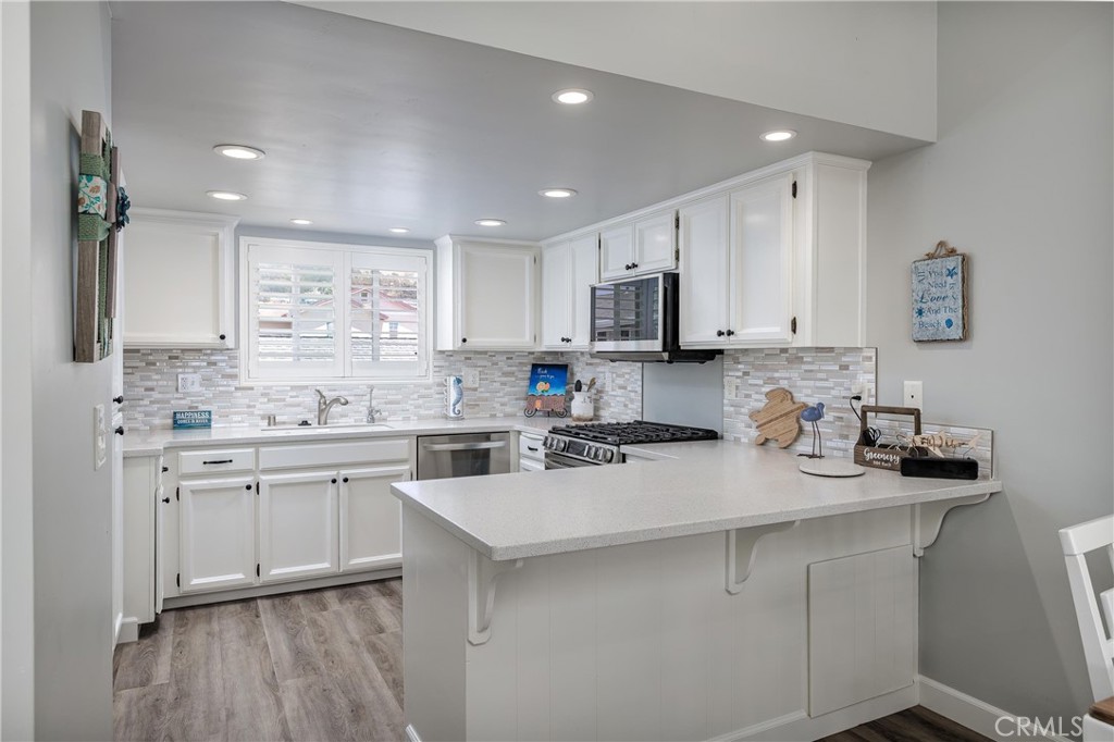 309 Sequoia Street, Unit 3 Morro Bay, CA 93442 - Photo 7 of 20 a kitchen with appliances a sink and cabinets