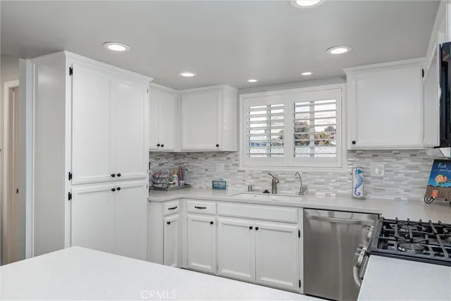a kitchen with kitchen island a stove and a refrigerator with wooden floor