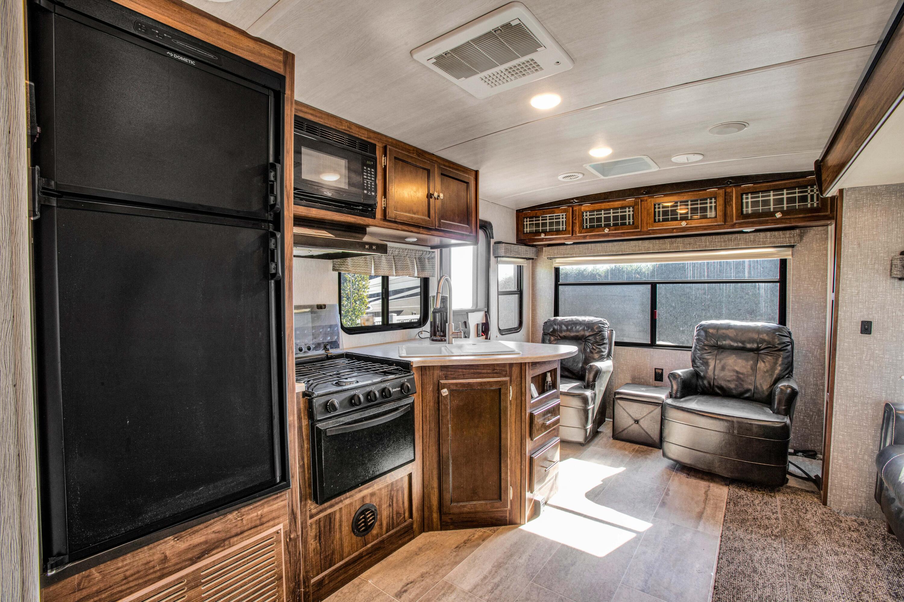 69411 Ramon Road, Unit 269 Cathedral City, CA 92234 - Photo 16 of 62 a kitchen with stainless steel appliances granite countertop a refrigerator a stove and a sink