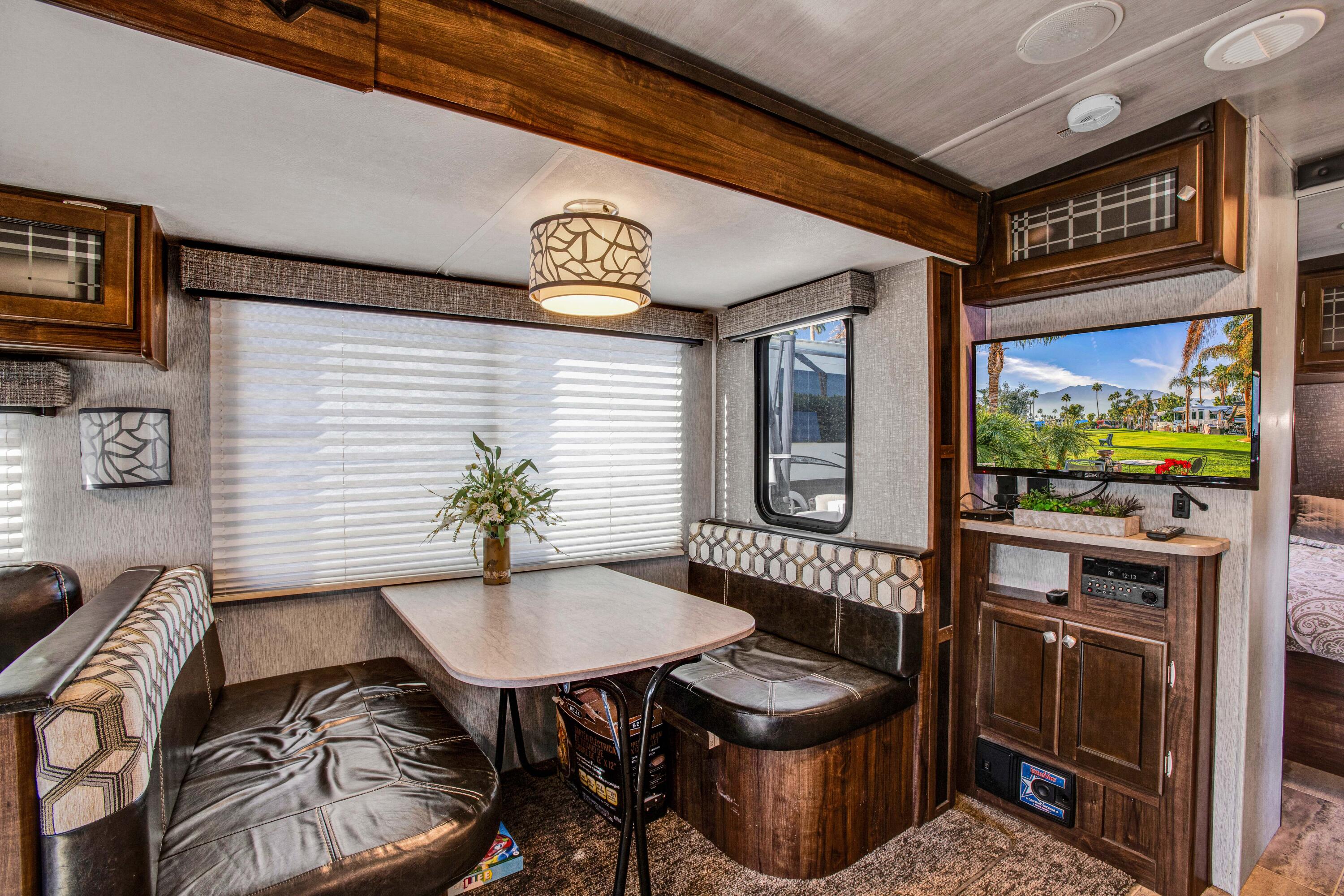 69411 Ramon Road, Unit 269 Cathedral City, CA 92234 - Photo 18 of 62 a kitchen with a table chairs and a refrigerator