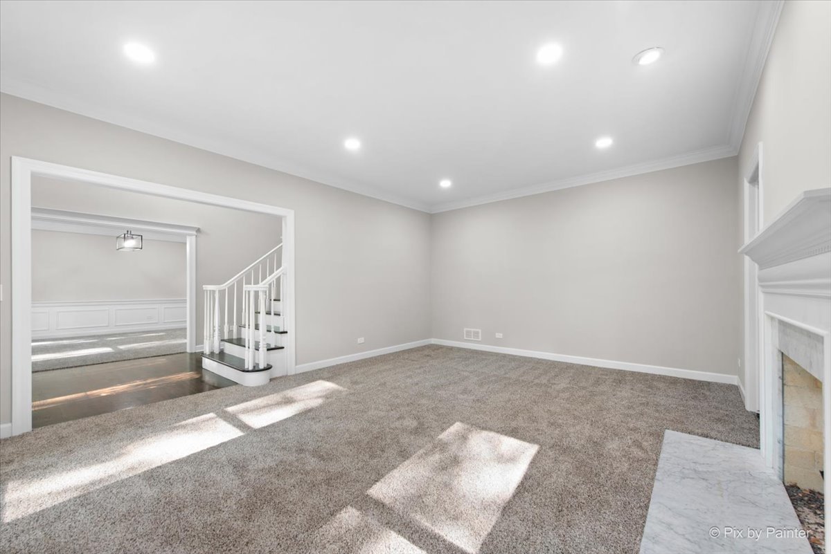 4N633 Hidden Oaks Road St. Charles, IL 60175 - Photo 12 of 49 an empty room with floor to ceiling window and fireplace