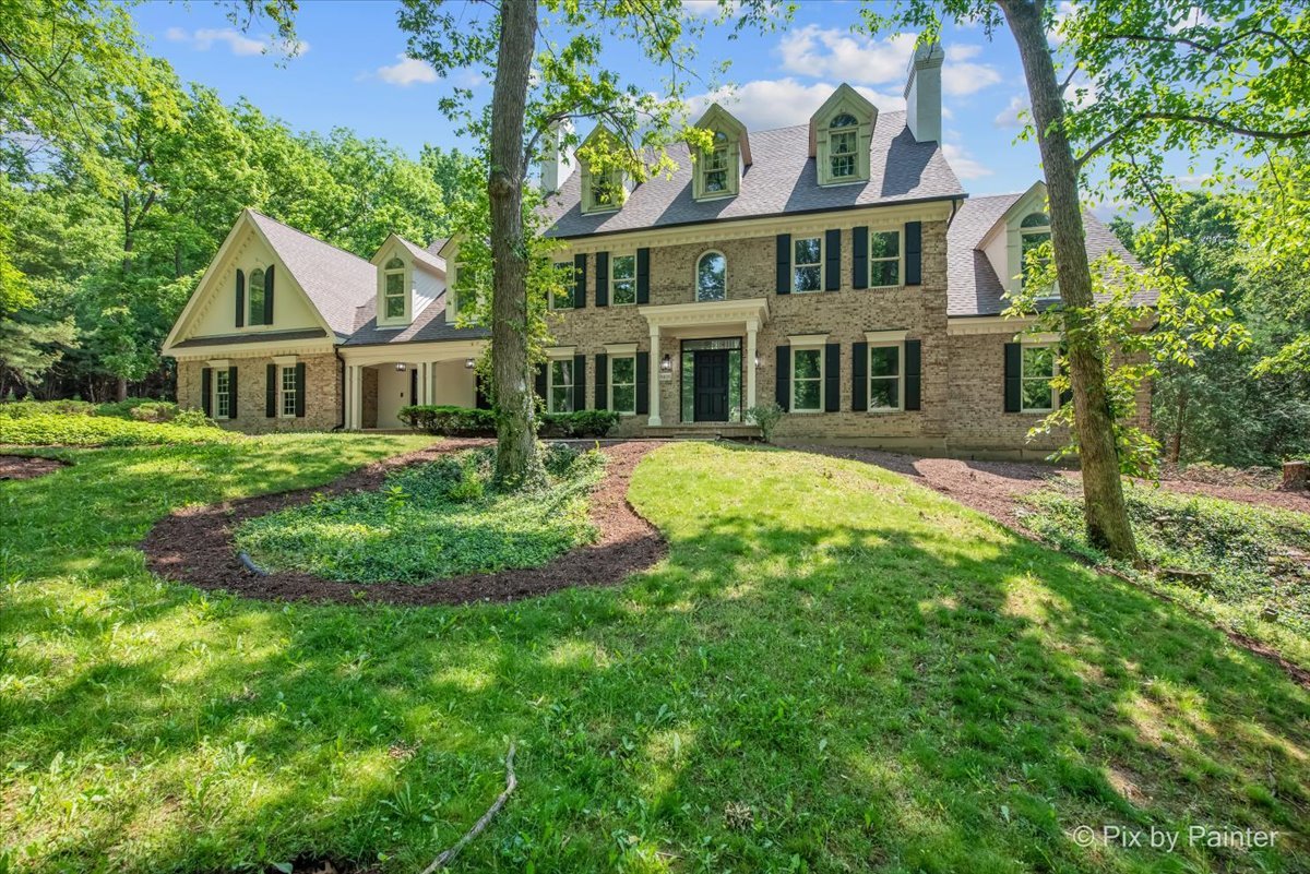 4N633 Hidden Oaks Road St. Charles, IL 60175 - Photo 2 of 49 a front view of a house with a garden and trees