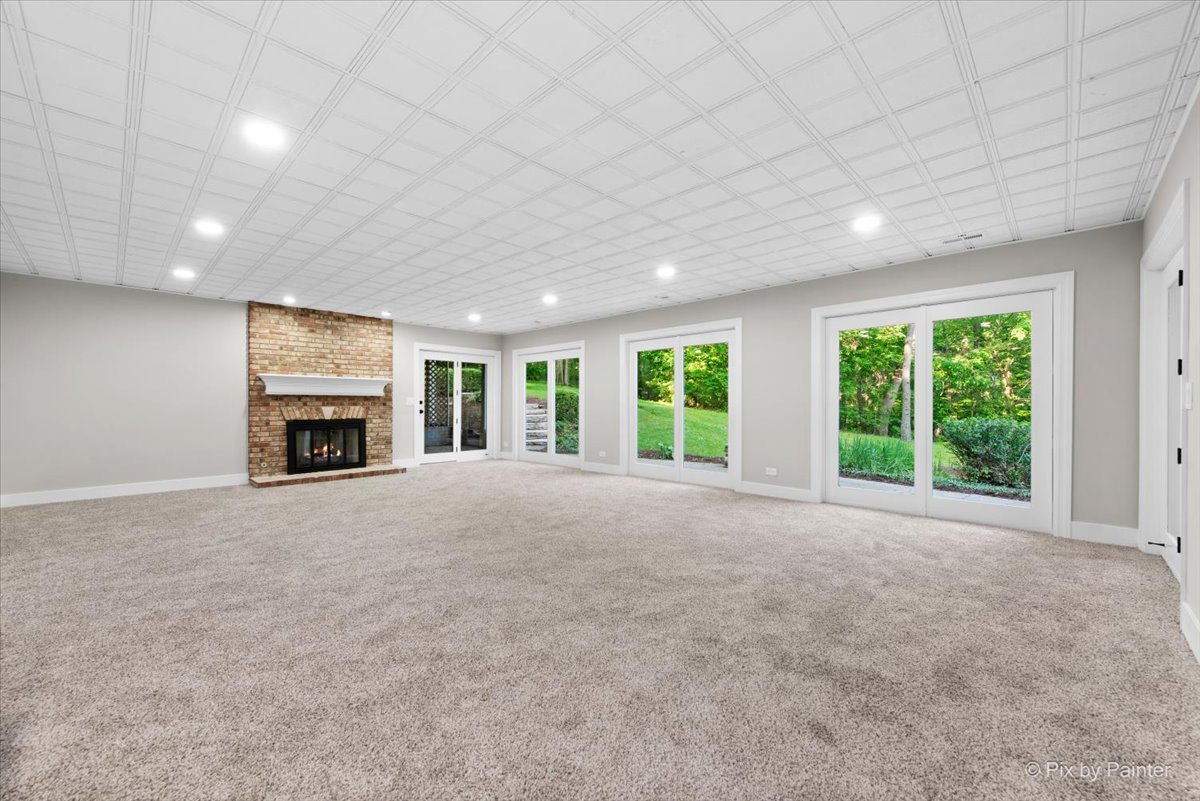 4N633 Hidden Oaks Road St. Charles, IL 60175 - Photo 46 of 49 a view of an empty room with a fireplace and a window