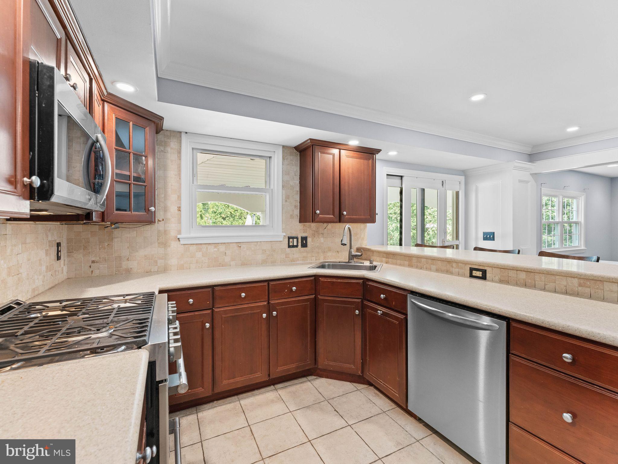 8 Chesterfield Road Sewell, NJ 08080 - Photo 13 of 57 a kitchen with a sink window and cabinets