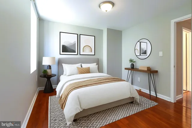 a bedroom with a bed lamp and a window