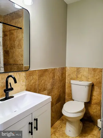 a bathroom with a sink a toilet and mirror