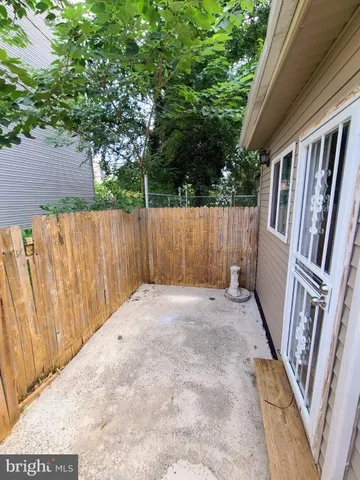 a view of an outdoor space with wooden fence