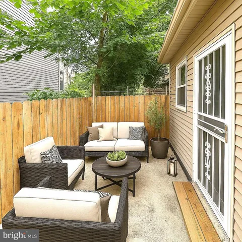 a balcony with furniture and a potted plant