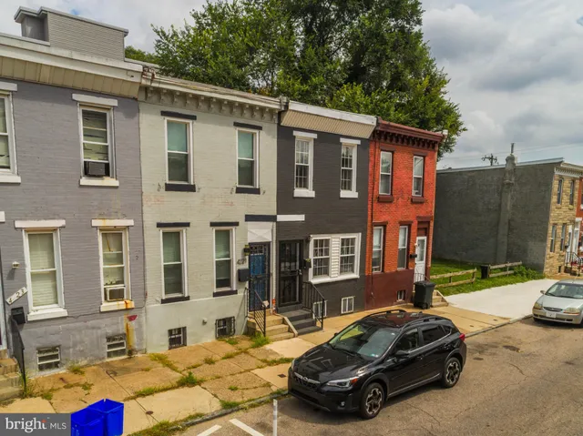 a car parked in front of a brick house