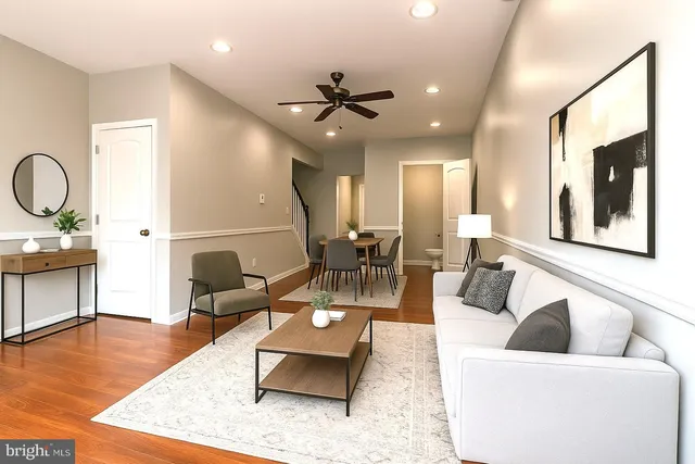 a living room with furniture and wooden floor