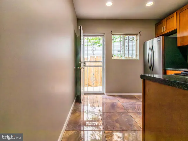 a view of a livingroom with wooden floor and a window