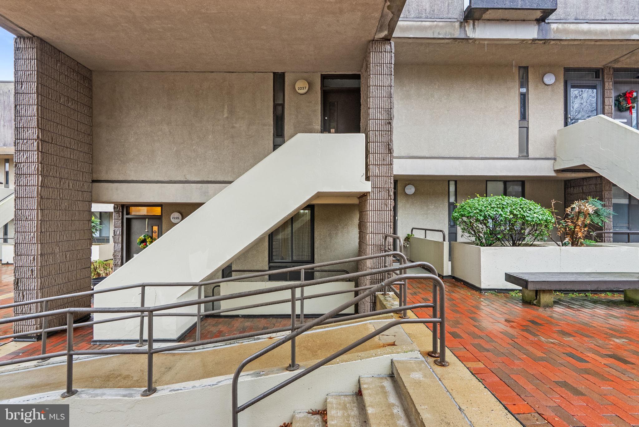 a balcony with chairs and wooden floor