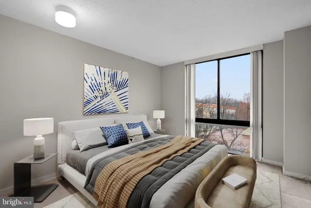 a bedroom with a bed and a painting on the wall