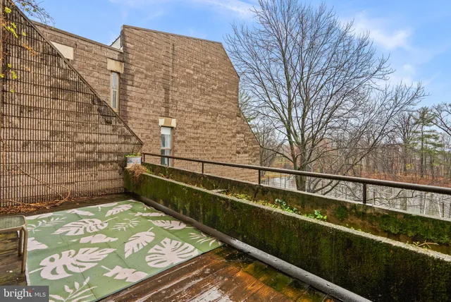 a view of balcony with wooden floor and fence