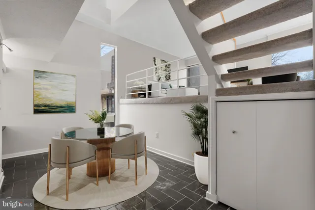 a dining room with furniture and window