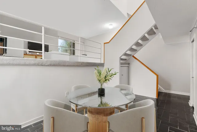 a dining room with furniture and wooden floor