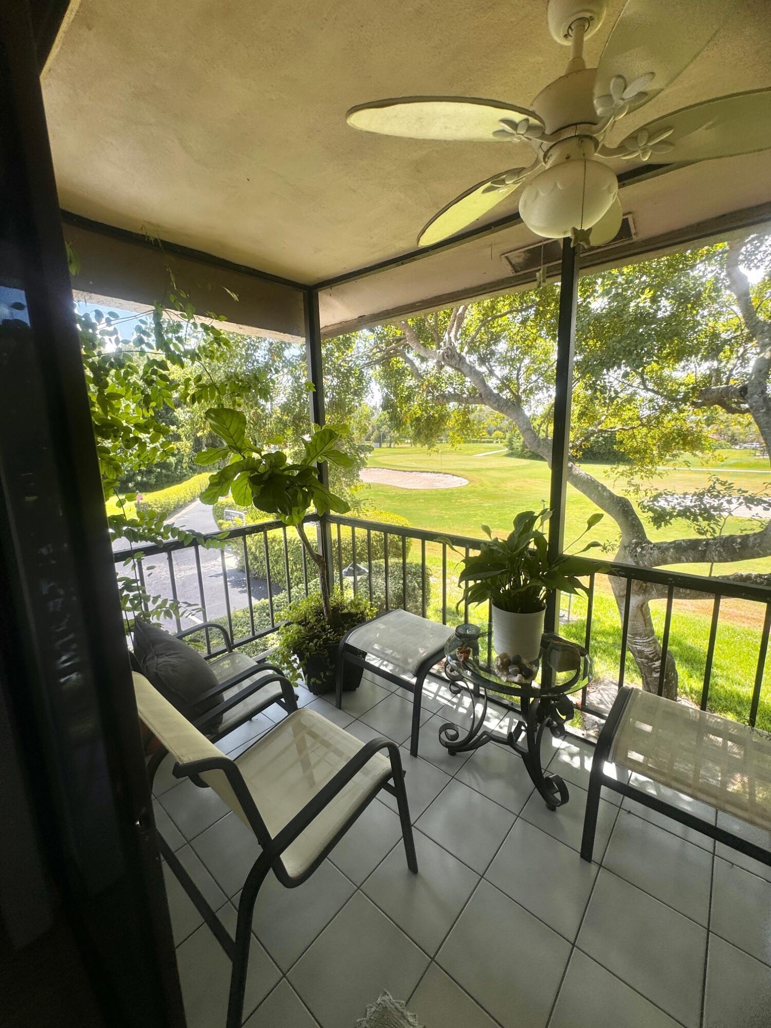 21411 Juego Circle, Unit 32B Boca Raton, FL 33433 - Photo 4 of 7 a living room with patio furniture and a floor to ceiling window
