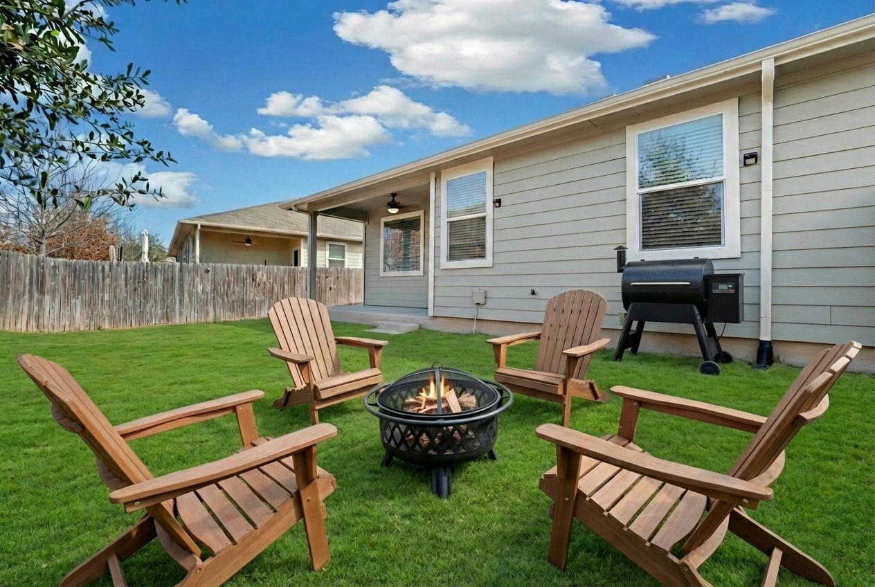 14409 Frankel Loop, Unit 33A Pflugerville, TX 78660 - Photo 25 of 28 a view of a chair and table in backyard of the house