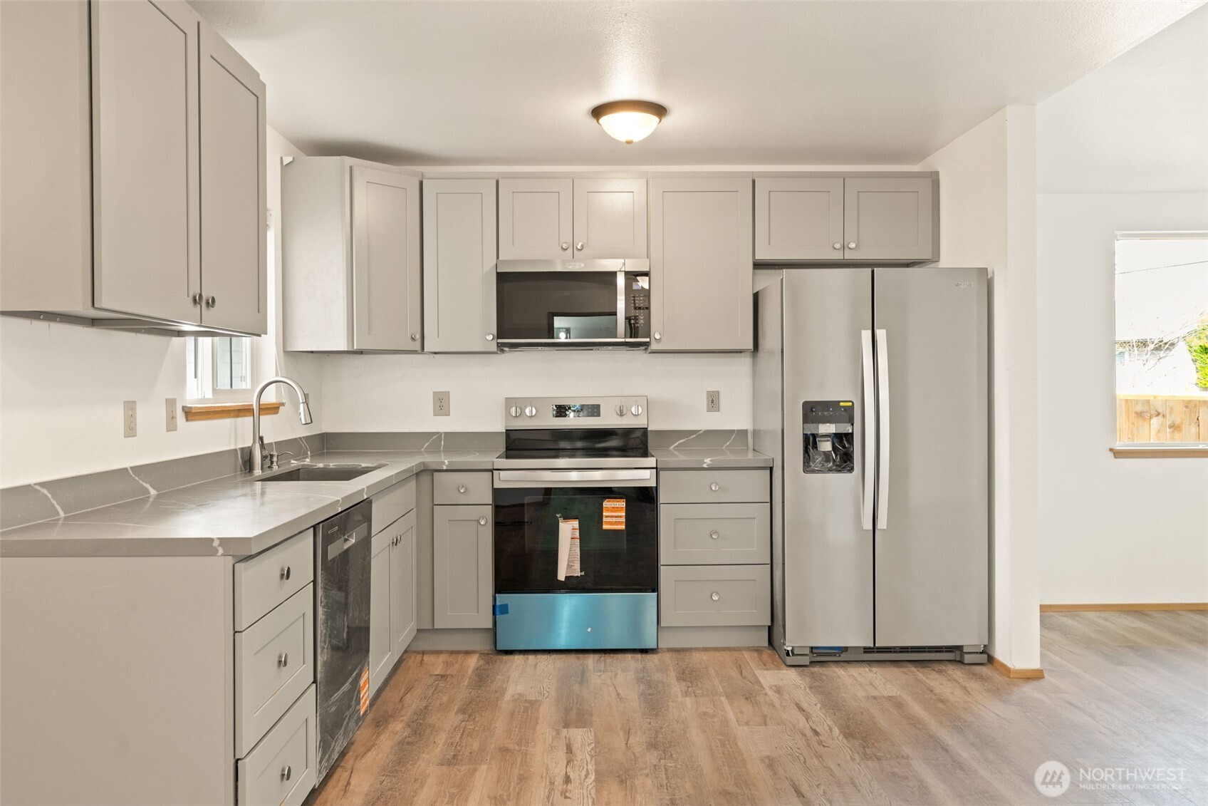 4021 167th Street Northeast, Unit A Arlington, WA 98223 - Photo 5 of 23 a kitchen with stainless steel appliances a stove a sink and a refrigerator