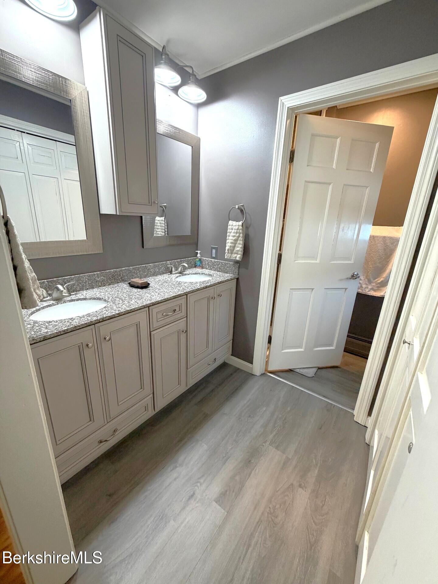 8 Country Road Adams, MA 01220 - Photo 19 of 44 a bathroom with a granite countertop sink and mirror with bathtub