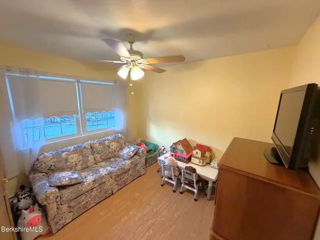 a bedroom with furniture and a window