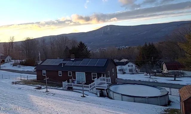 a view of a chairs and table in patio