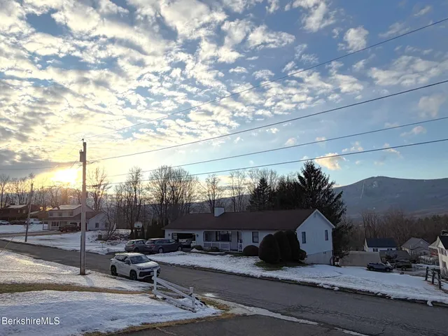 a view of a back yard of the house and car parked