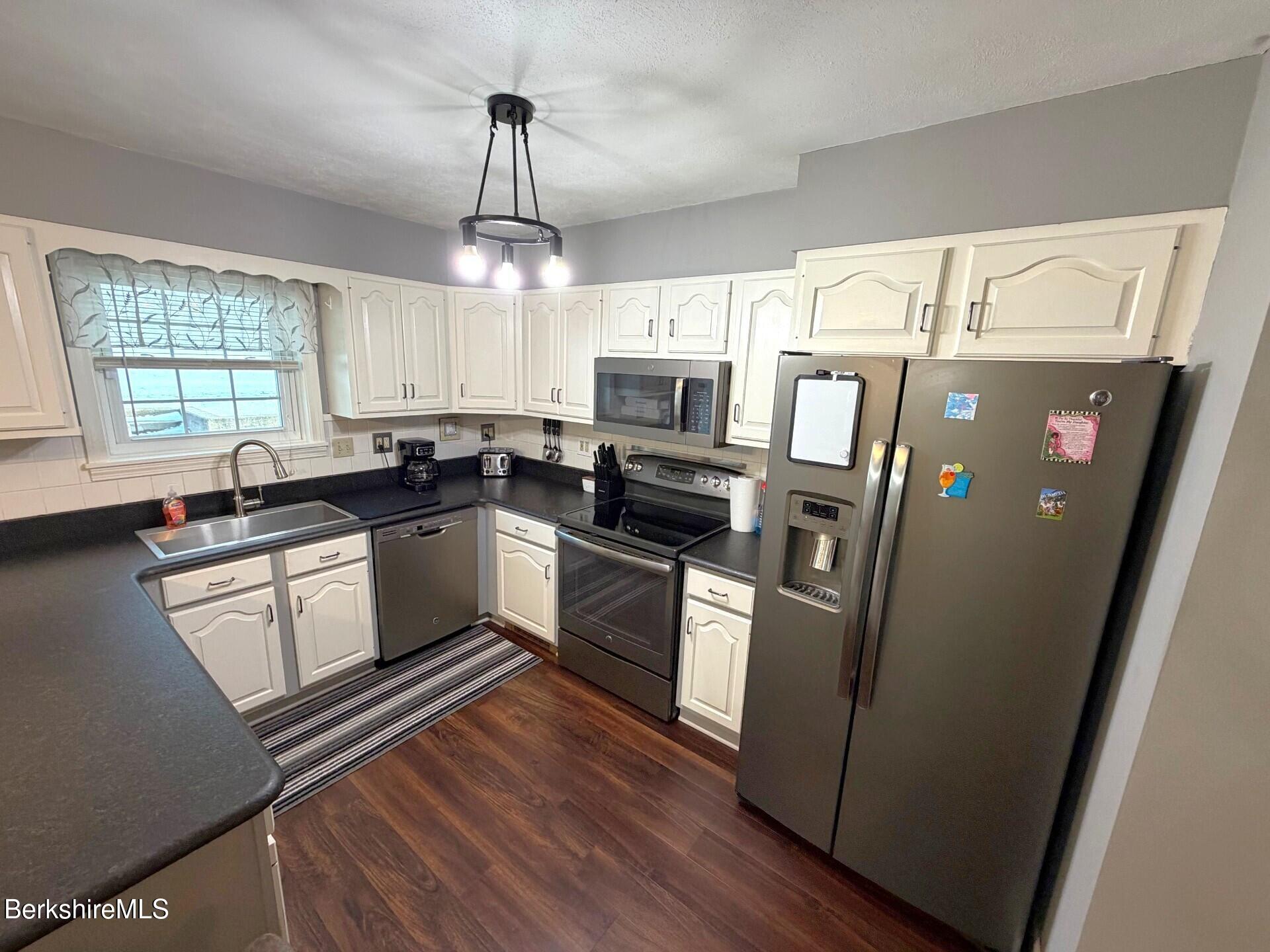 8 Country Road Adams, MA 01220 - Photo 9 of 44 a kitchen with stainless steel appliances a refrigerator sink and microwave