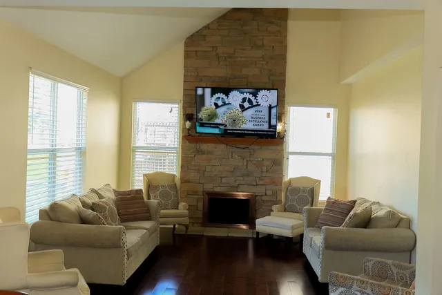a living room with furniture and a fireplace