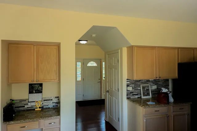 a kitchen with a refrigerator and cabinets