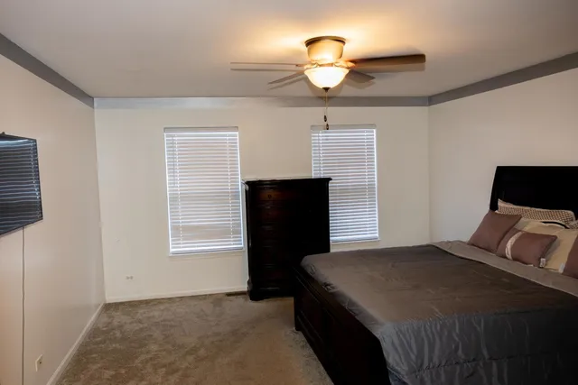 a bedroom with a bed and a television