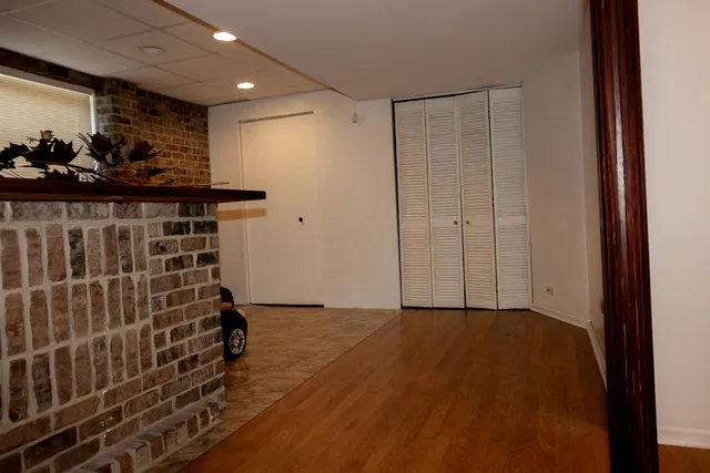 a view of a room with wooden floor