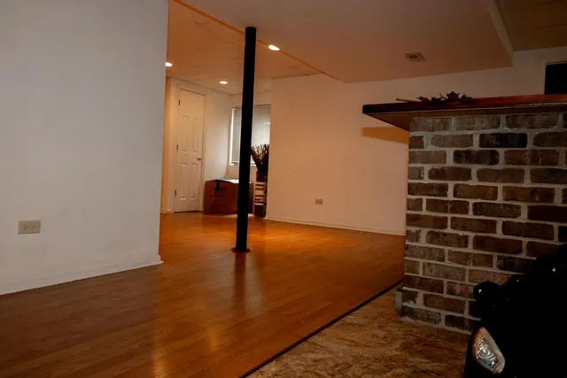 a view of a room with wooden floor
