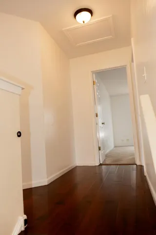 an empty room with wooden floor