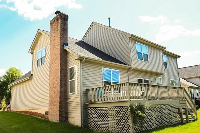 a view of a house with a wooden fence