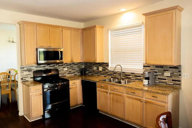 a kitchen with stainless steel appliances a stove a sink and a microwave