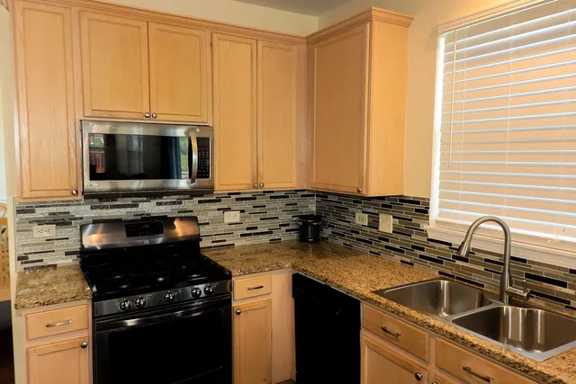 a kitchen with a sink stove and microwave