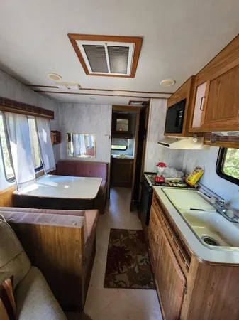a kitchen with a refrigerator and a stove top oven