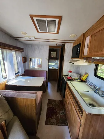 a kitchen with a refrigerator and a stove top oven