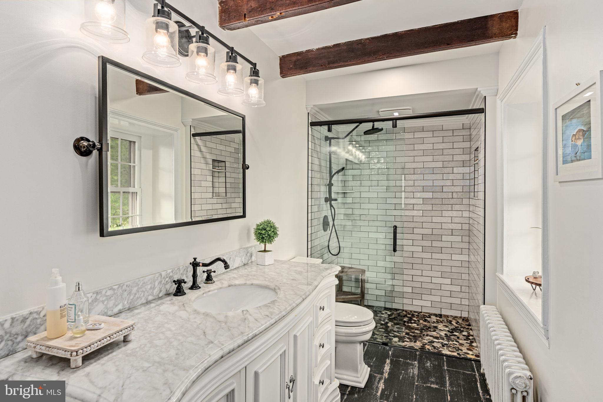 137 Callowhill Road Chalfont, PA 18914 - Photo 32 of 59 a bathroom with a granite countertop sink toilet a mirror and shower
